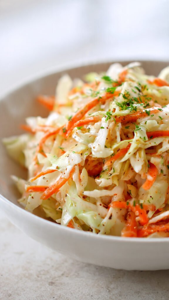 a crisp coleslaw with shredded cabbage and carrots